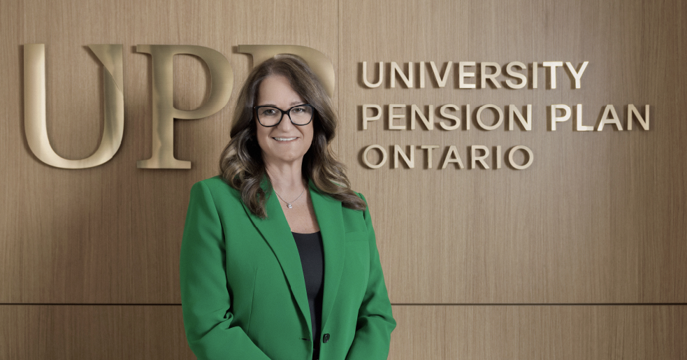 Joanna, Chief Pension Services Officer, standing in front of the UPP logo.
