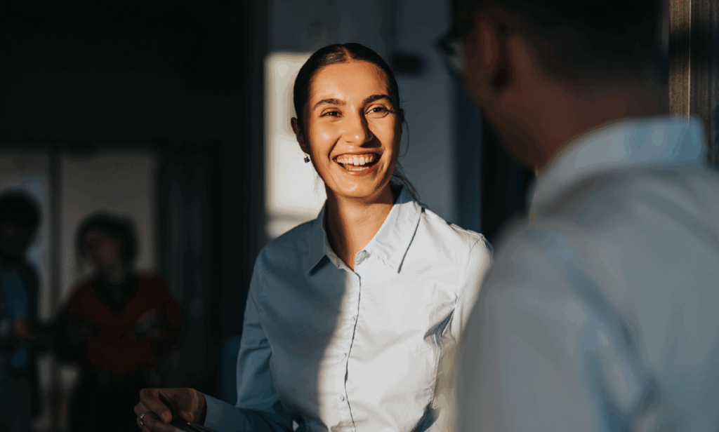 Woman in an office conversing with a colleague